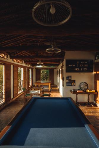 a pool table in the middle of a room at Hotel Finca Buenos Aires Barichara in Barichara