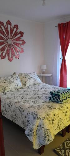a bed with a comforter on it in a bedroom at Encanto Rural - Casa de campo para disfrutar y olvidar el estrés in Putaendo