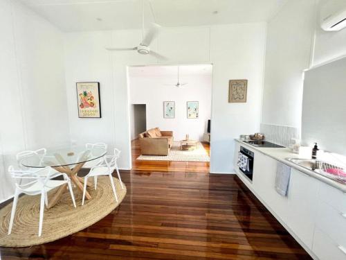 a kitchen and dining room with a table and chairs at Townsville Suites in Townsville