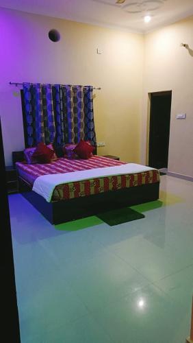 a bedroom with a bed with a purple and blue canopy at The Mountain View Home Stay in Khajurāho