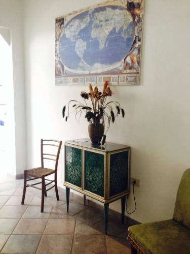 a vase with flowers on a table in a room at Hotel Flora in Cesenatico