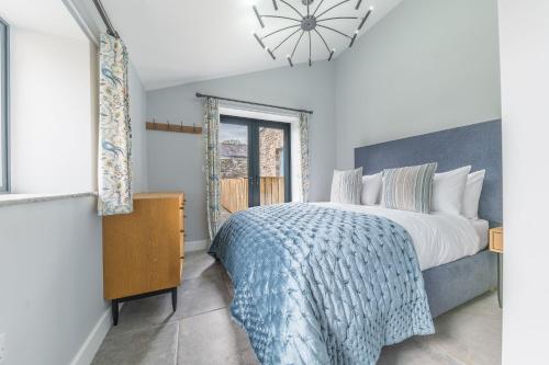 a bedroom with a large bed and a window at No 2 The Coach House in Carnforth