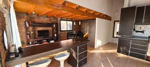 a kitchen with a large counter top in a room at Departamento completo in Ciudad Lujan de Cuyo