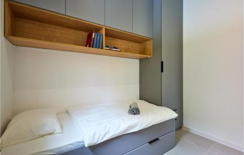 a small room with a bed with white sheets at Wellness House By The Lake in Trakoščansko Jezero