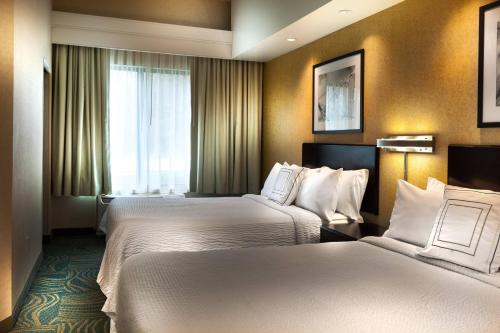 a hotel room with two beds and a window at SpringHill Suites Dallas DFW Airport North/Grapevine in Grapevine