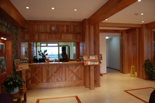 a lobby with a reception counter in a building at Hotel Tierra del Fuego in Ushuaia