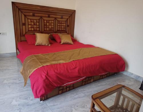a bedroom with a large bed with a red blanket at Hide and Seek by StayApart in Dehradun
