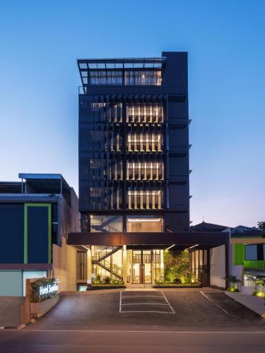 a building with a parking lot in front of it at Hotel Santika PasirKaliki in Bandung