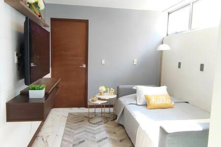 a bedroom with a bed and a small table at Orozco MaiaHome-POLANCO 1BR close to Antara in Mexico City
