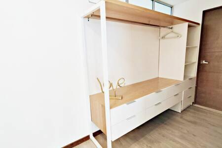 a closet with white cabinets in a room at Rivera MaiaHome-Hermoso apt en Polanco cerca Antara - 2BR 2BT in Mexico City