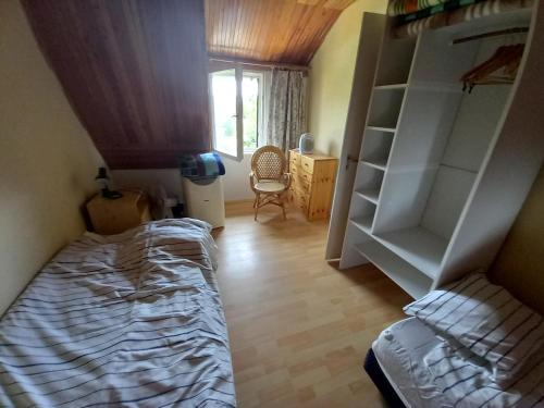 a bedroom with a bed and a book shelf at View Berry House in Csopak