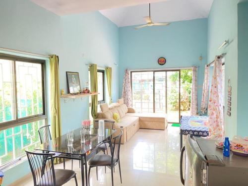 a living room with a table and chairs and a couch at 2BHK Luxurious Villa with Pool in Shenwa
