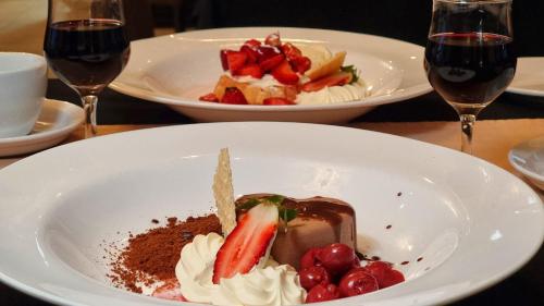 a plate of dessert with a strawberry and chocolate at Silver Haven Motor Inn in Broken Hill