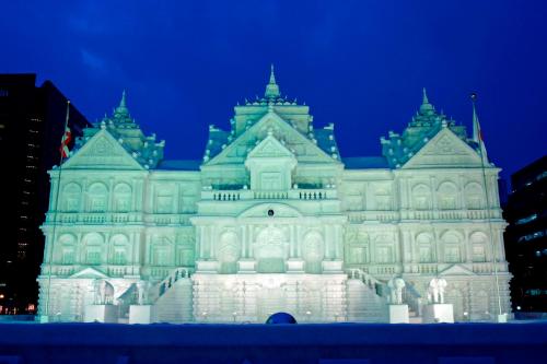 a large building is lit up at night at LUCENT in Toyohira