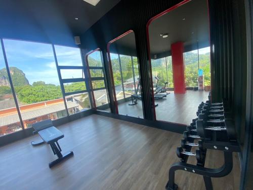 a gym with chairs and a wooden floor and windows at Infinity Aonang Krabi in Ao Nang Beach