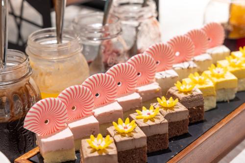 a bunch of desserts on a tray on a table at Home2 Suites by Hilton Hefei South Railway Station in Hefei