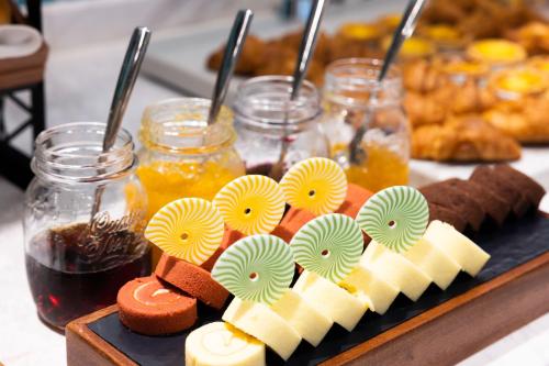 a tray of cheese and other desserts on a table at Home2 Suites by Hilton Hefei South Railway Station in Hefei
