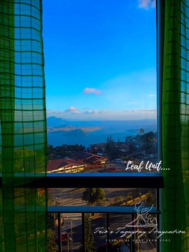 a view of the ocean from a building window at Leaf Taal View No Balcony in Tagaytay