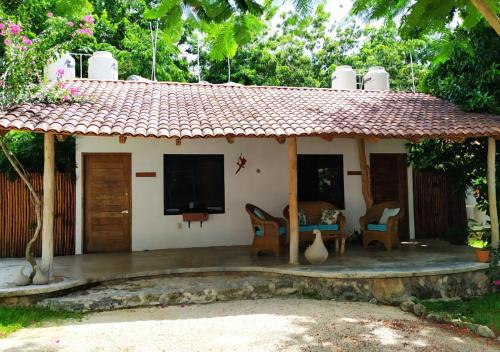 a small house with a porch and a tv at Estancia Lapislázuli in Bacalar