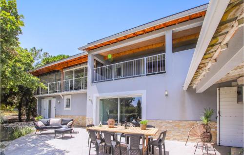 a patio with a table and chairs in front of a house at Nice Home In Suze-La-Rousse With Wifi in Suze-la-Rousse