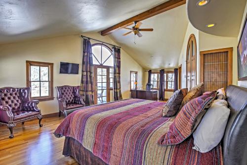 a bedroom with a large bed and two chairs at Mountaineer Manor in Glenwood Springs