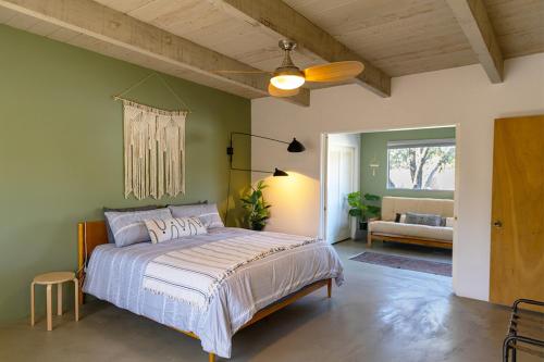 a bedroom with a bed and a couch in a room at Designer Hideaway in Borrego Springs