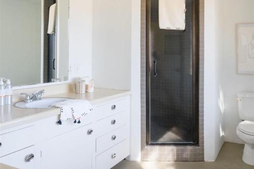 a bathroom with a sink and a toilet and a shower at Designer Hideaway in Borrego Springs