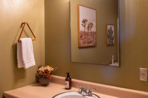 a bathroom with a sink and a mirror at Designer Hideaway in Borrego Springs