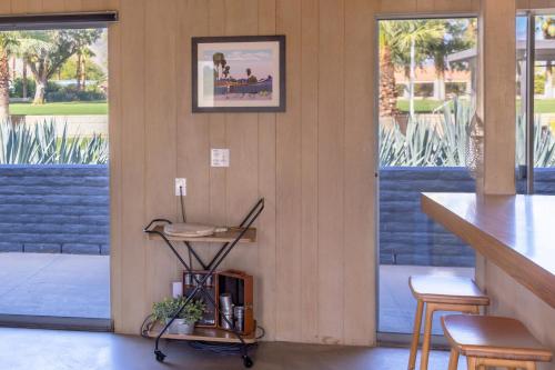 a room with a counter and chairs and windows at Designer Hideaway in Borrego Springs