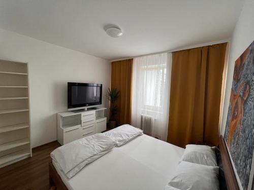 a bedroom with a bed and a flat screen tv at Apartment in Frankfurt