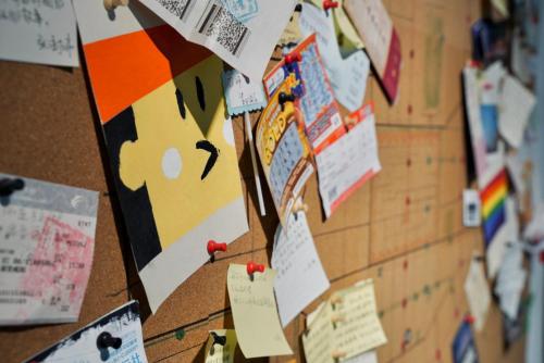 a bulletin board with many pieces of paper on it at Sifang Space Hostel Xi'an - Xi'an TIYUCHANG metro station Line2 in Xi'an