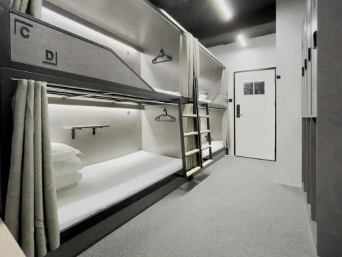 a room with a bunk bed with a toilet in it at Sifang Space Hostel Xi'an - Xi'an TIYUCHANG metro station Line2 in Xi'an