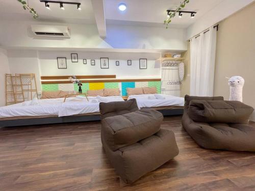 a bedroom with a bed and a couch and chairs at Sunway Geo Suite-Linked BRT-Medical in Petaling Jaya