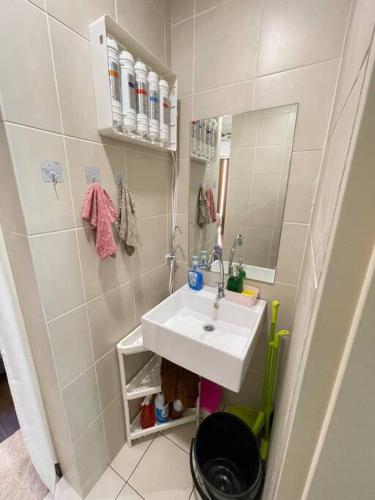 a small bathroom with a sink and a mirror at Sunway Geo Suite-Linked BRT-Medical in Petaling Jaya