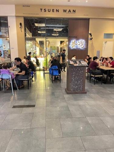 a group of people sitting at tables in a restaurant at Sunway Geo Suite-Linked BRT-Medical in Petaling Jaya
