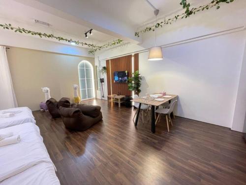 a living room with a bed and a table and chairs at Sunway Geo Suite-Linked BRT-Medical in Petaling Jaya