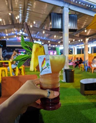 a person is holding a drink with at Bposhtels Houston in Houston