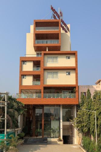 a tall building with a lot of windows at Hotel Aditya Mansingh Inn in Somnath