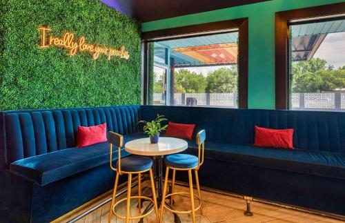 a restaurant with a blue bench and a table and chairs at Bposhtels Houston in Houston