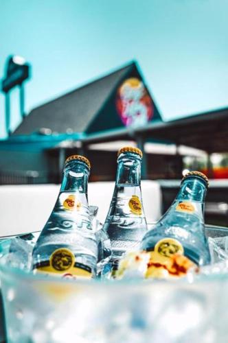 two bottles of beer sitting on top of a table at Bposhtels Houston in Houston