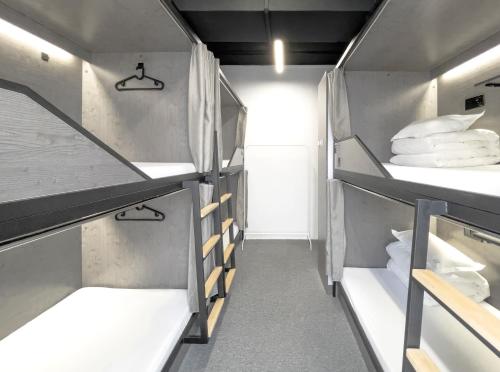 a walk in closet with shelves in a room at Sifang Space Hostel Xi'an - Xi'an TIYUCHANG metro station Line2 in Xi'an