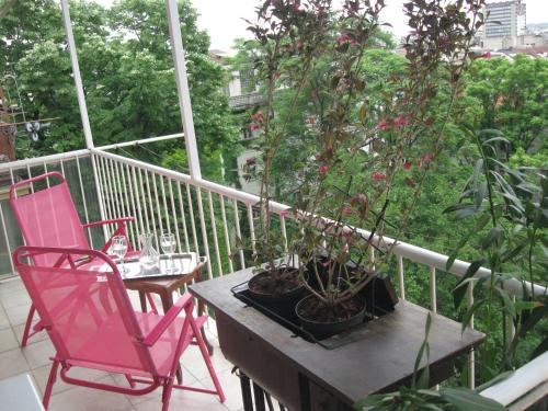 a balcony with two chairs and a table with a plant at Gajba Apartment in Belgrade
