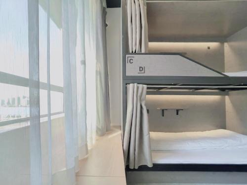 a bunk bed in a room with a window at Sifang Space Hostel Xi'an - Xi'an TIYUCHANG metro station Line2 in Xi'an