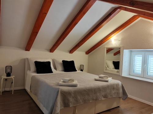 a bedroom with a bed with two towels on it at Dubrovnik house - Leni in Komolac