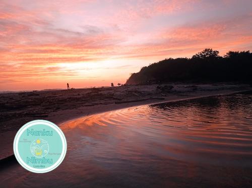 a sunset at the beach with a sticker on it at Nanku Nimbu Casa-Bus equipada cerca de playas in Sámara