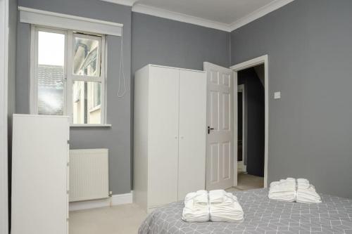 a bedroom with a bed with two pillows on it at Peaceful & Spacious Family Home In Eastbourne! in Eastbourne