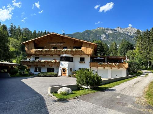 a large building with mountains in the background at W5 Haus Ganghofer in Leutasch