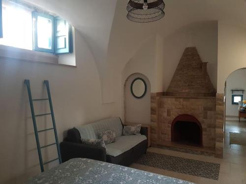 a living room with a couch and a fireplace at Dimora Grecale in Cisternino