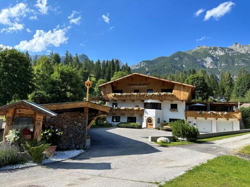 a house in the mountains with a driveway at W2 Haus Ganghofer in Leutasch
