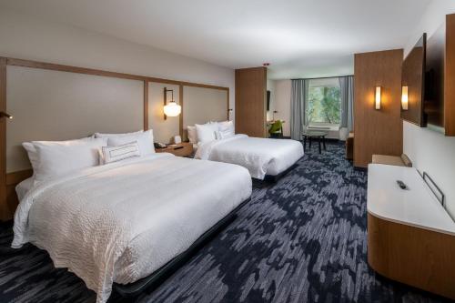 a hotel room with two beds and a large window at Fairfield Inn & Suites by Marriott Little Rock Airport in Little Rock
